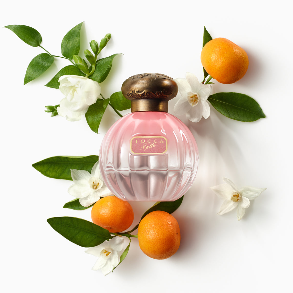 Belle Eau de Parfum bottle with flower and lime