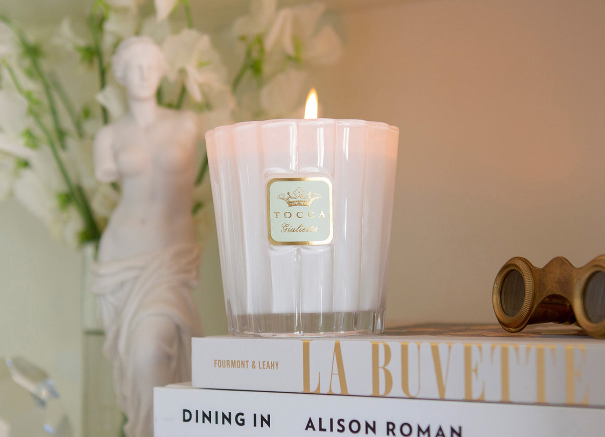 Giulietta Candle on a table with books