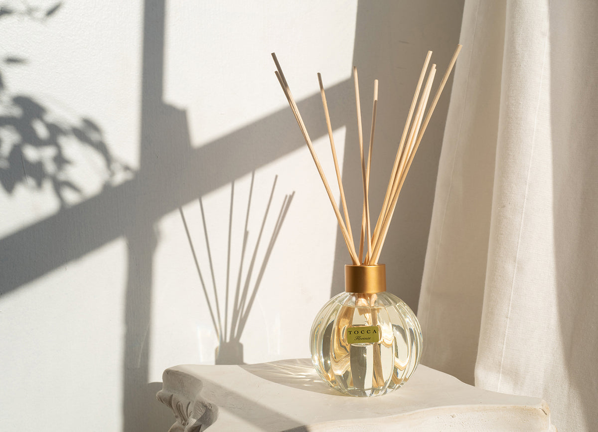 Tocca diffuser on a table near a sunny window